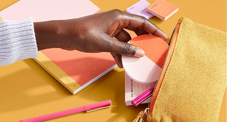 A person holding a piece of paper in their hand.