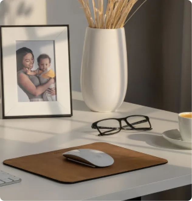 A picture of a woman holding a baby next to a computer mouse.